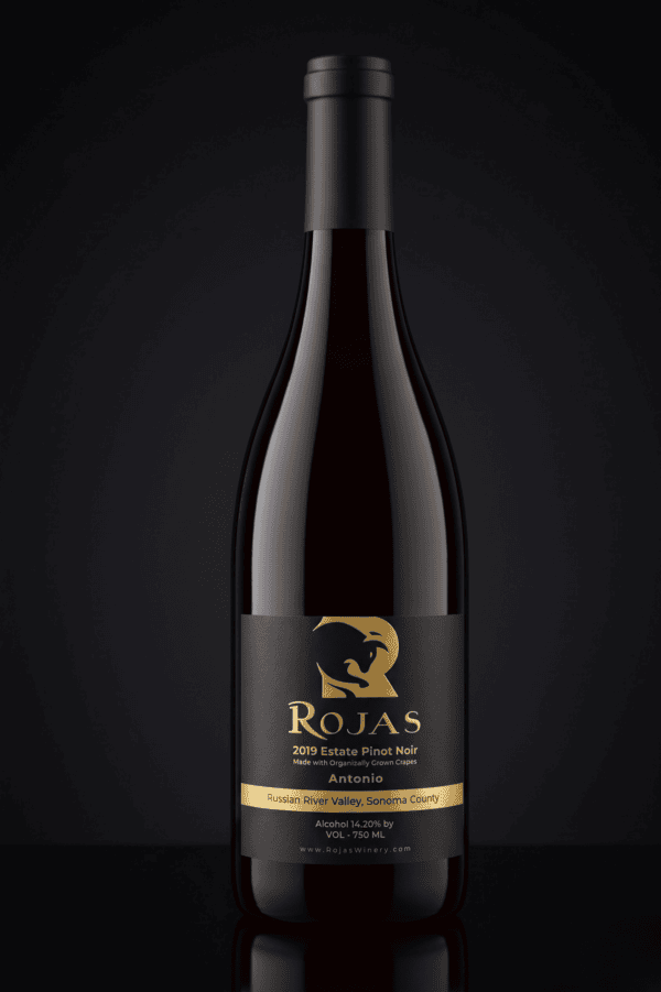 A dark wine bottle labeled Rojas 2019 Estate Pinot Noir, Russian River Valley, Sonoma County stands against a black background with gold accents and a stylized horse logo on the label.