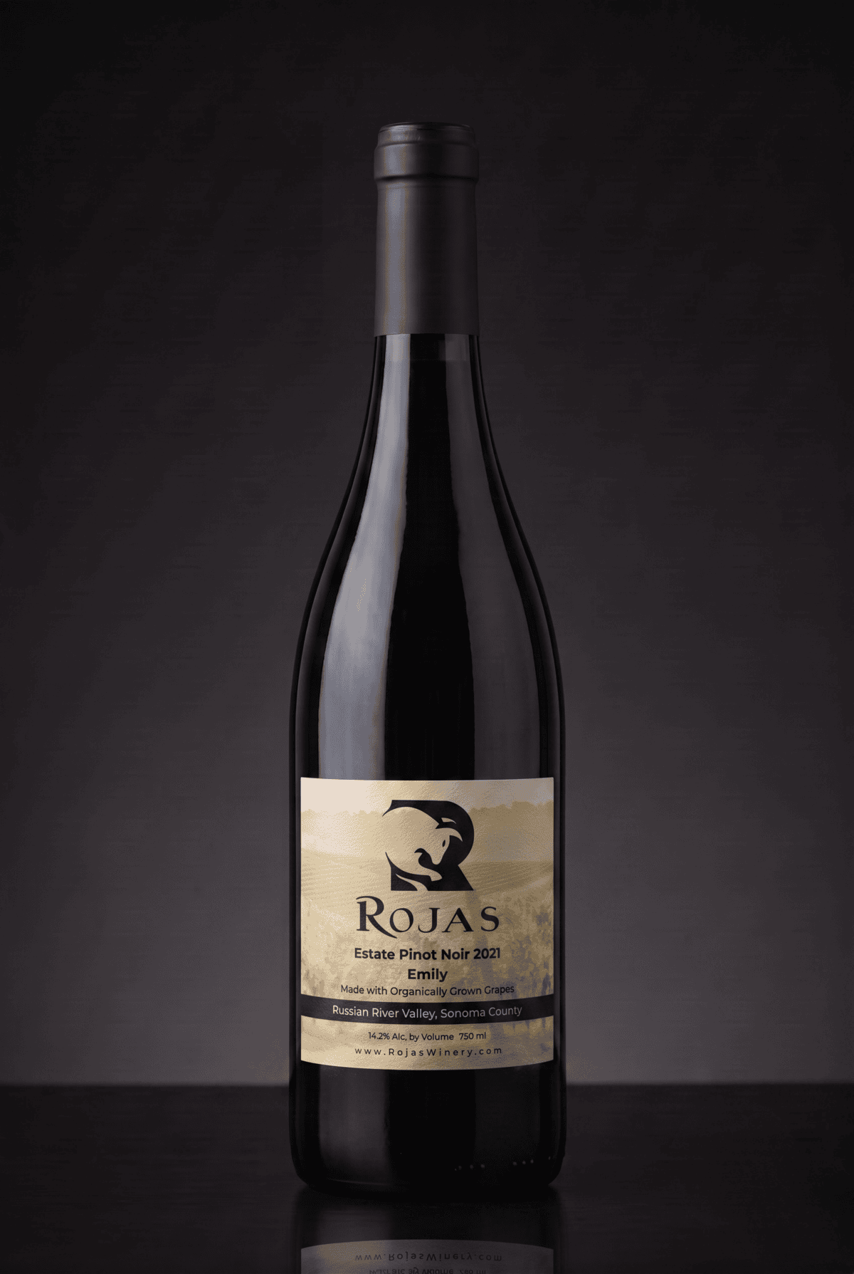 A bottle of Rojas Estate Pinot Noir 2021 wine with a black label showing a stylized bird logo, set against a dark, gradient background.