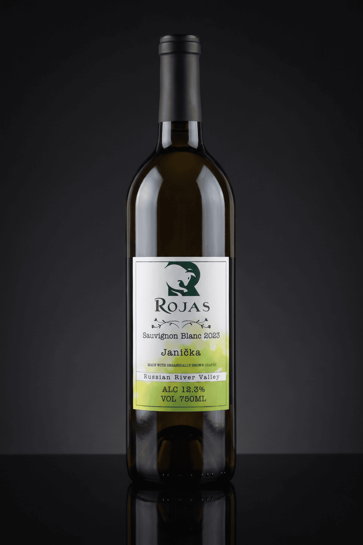 A bottle of Rojas Sauvignon Blanc 2023 wine with a black cap sits upright against a dark background. The label notes Russian River Valley, 12.9% alcohol, and a volume of 750ml.