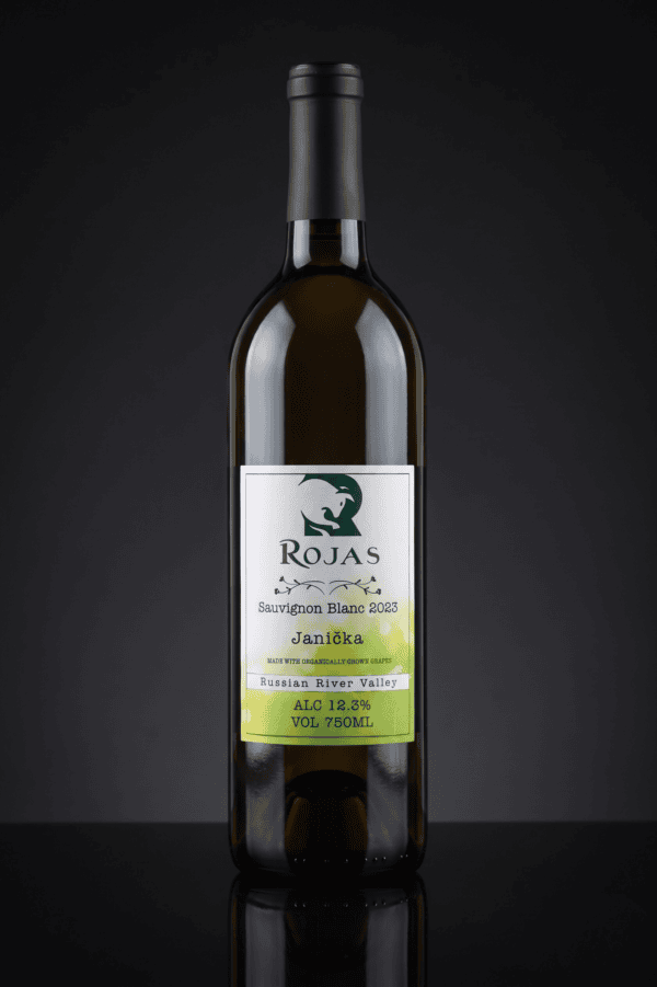 A bottle of Rojas Sauvignon Blanc 2023 wine with a black cap sits upright against a dark background. The label notes Russian River Valley, 12.9% alcohol, and a volume of 750ml.